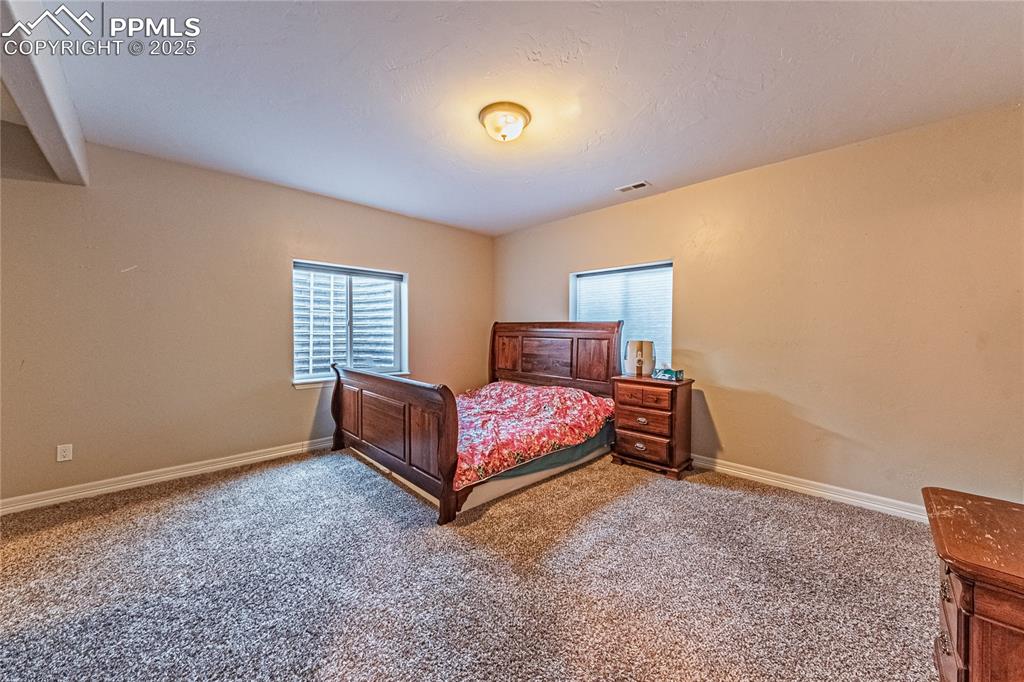 Image 25 of 36: Carpeted bedroom featuring baseboards and visible vents