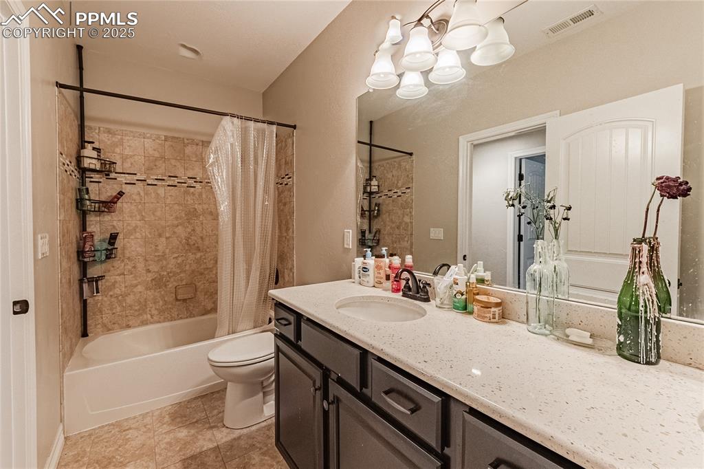 Image 30 of 36: Full bathroom with vanity, shower / bathtub combination with curtain, visib