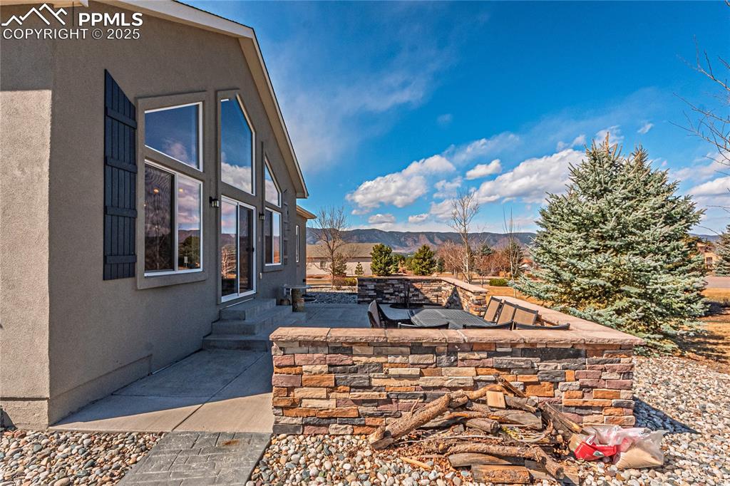Image 32 of 36: View of yard featuring entry steps, a patio area, and a mountain view