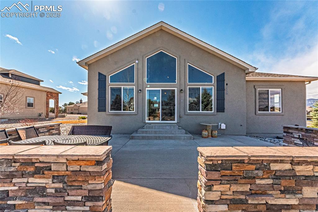 Image 33 of 36: Back of property with stucco siding and a patio area