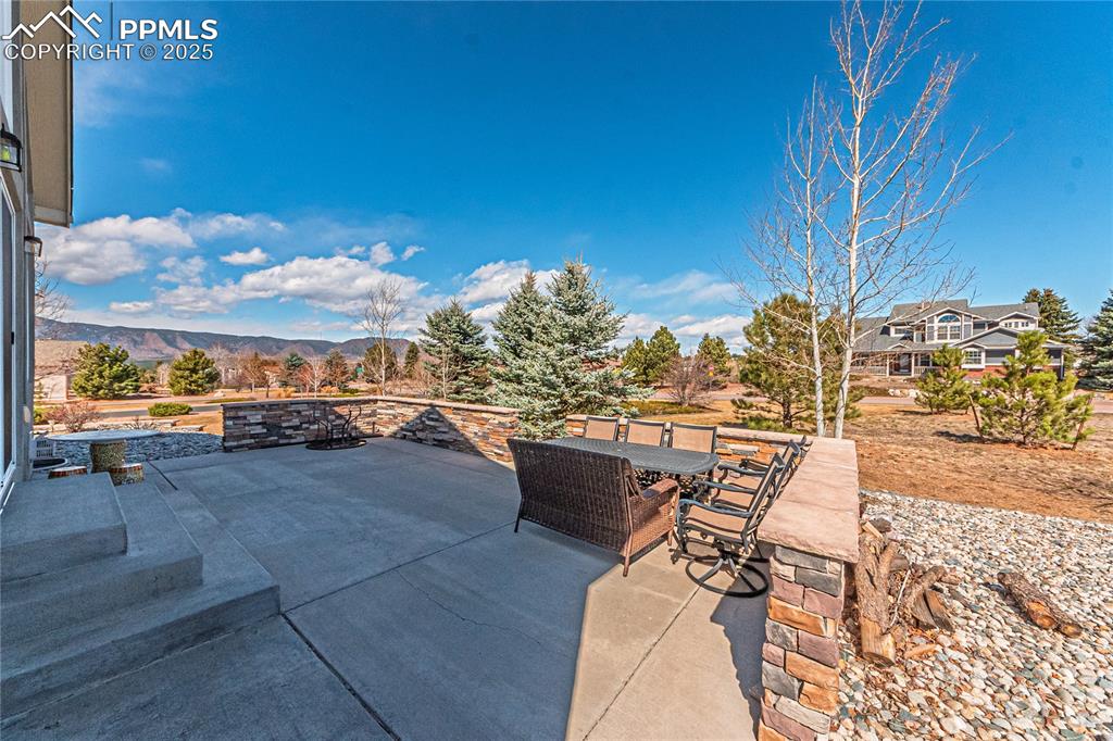 Image 35 of 36: View of patio with a mountain view and outdoor dining space