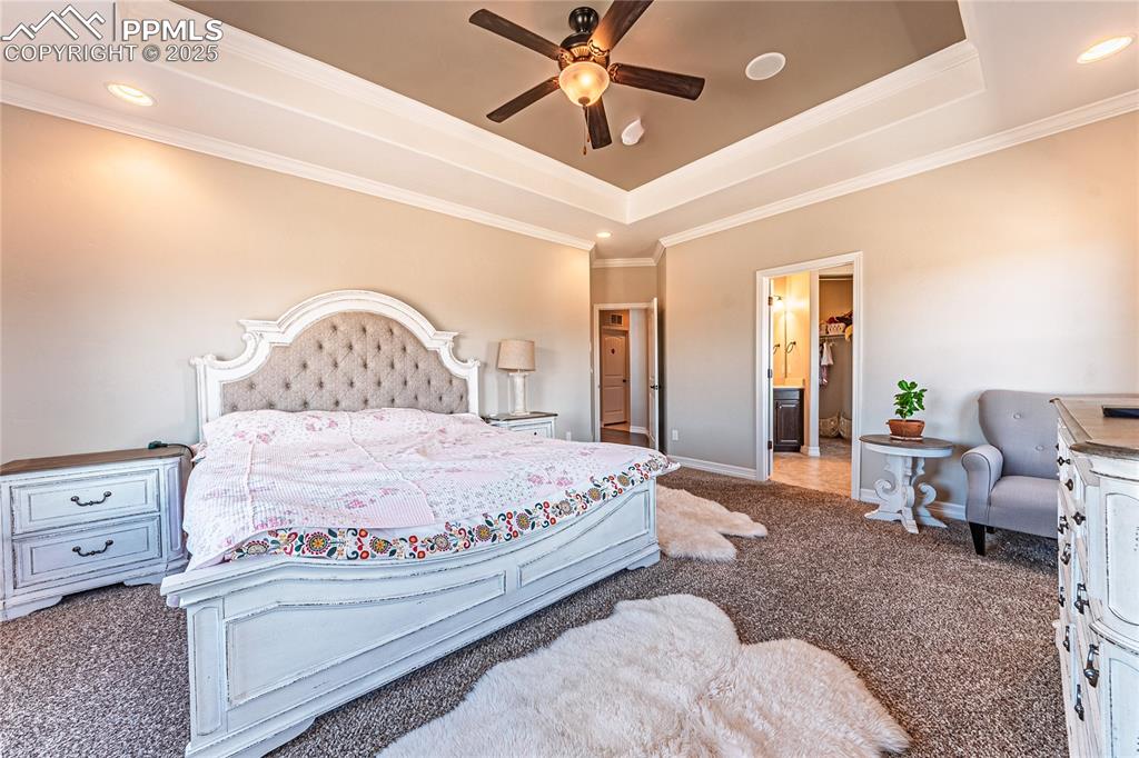 Image 9 of 36: Bedroom featuring baseboards, recessed lighting, ornamental molding, a rais