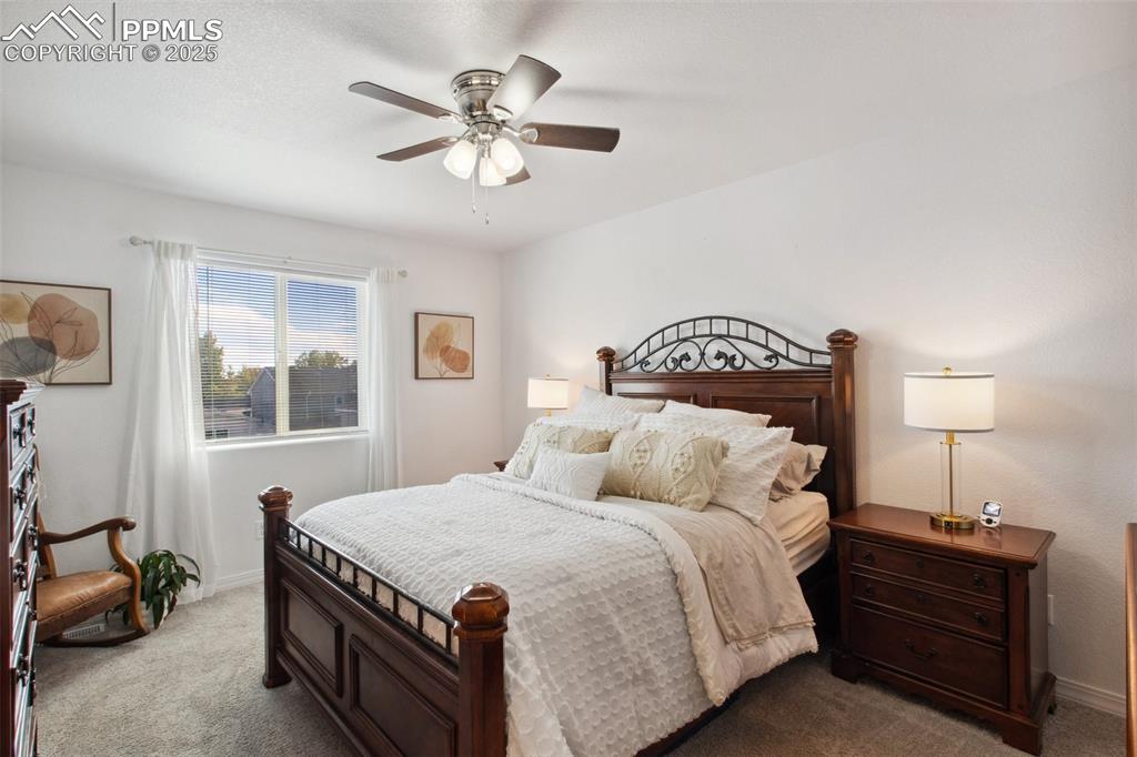 Image 7 of 27: Bedroom featuring baseboards, ceiling fan, and dark carpet