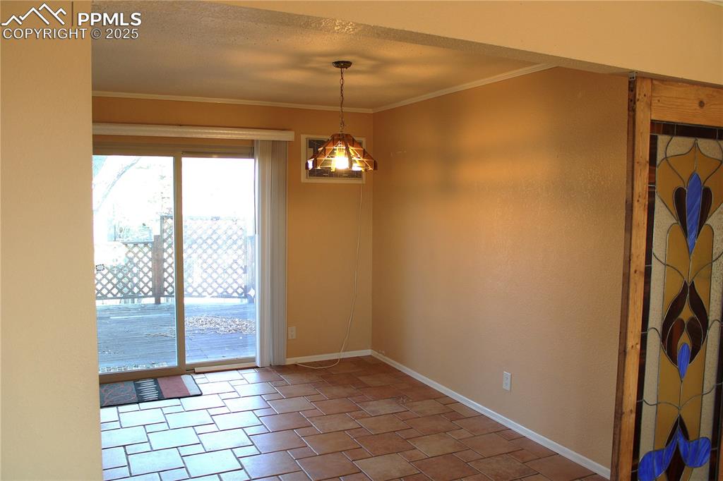 Image 10 of 48: Dining area with ornamental molding and a textured ceiling