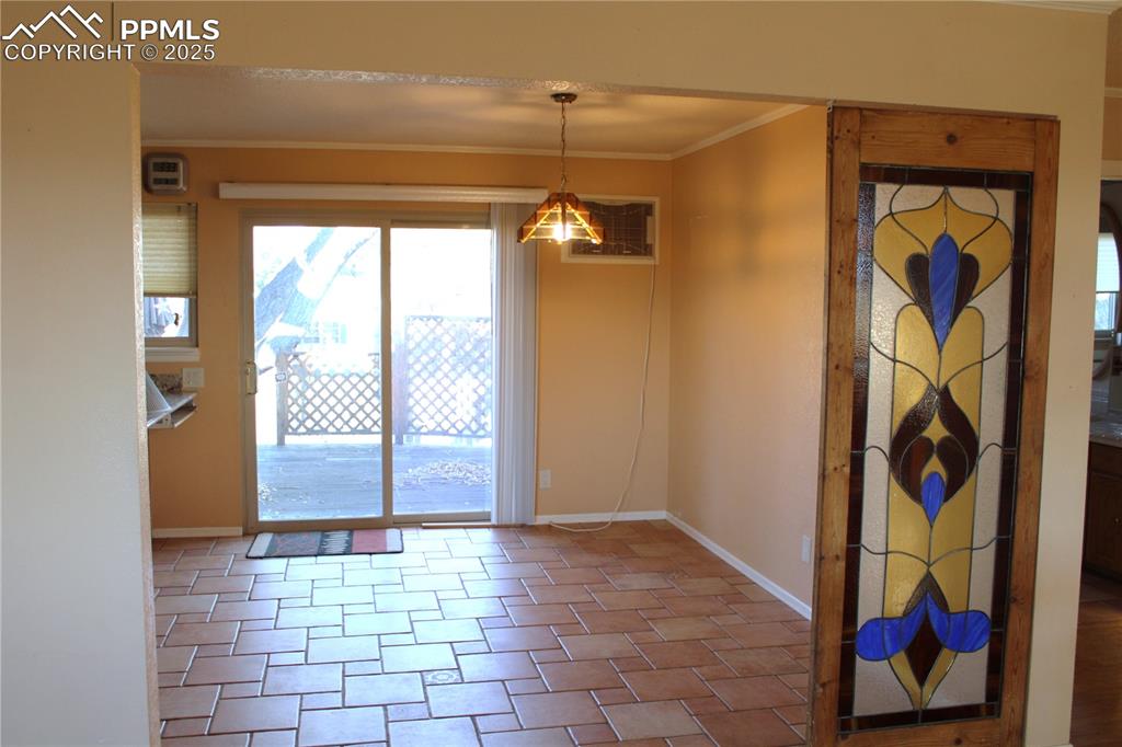 Image 11 of 48: Dining area featuring crown molding