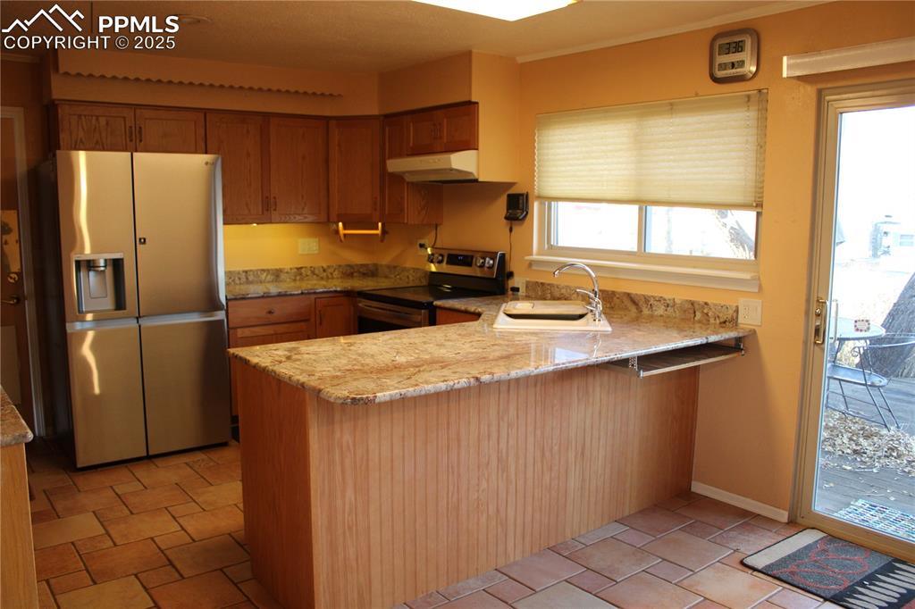 Image 17 of 48: Kitchen with appliances with stainless steel