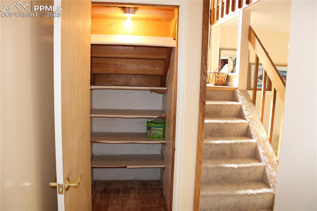 Image 28 of 48: Storage under the stairs