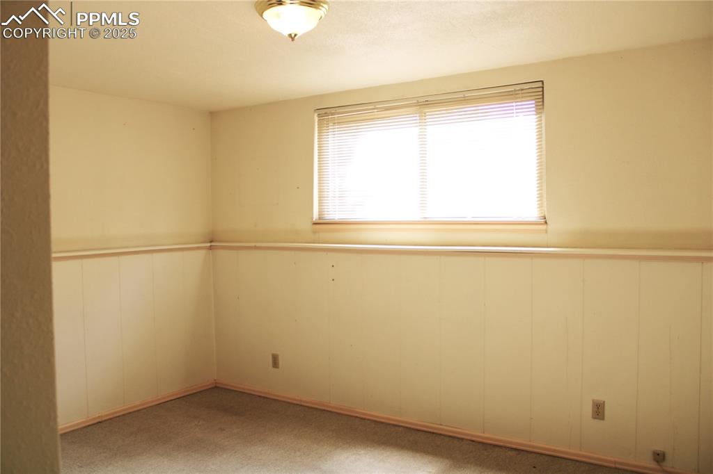 Image 33 of 48: Lower third bedroom featuring wainscoting