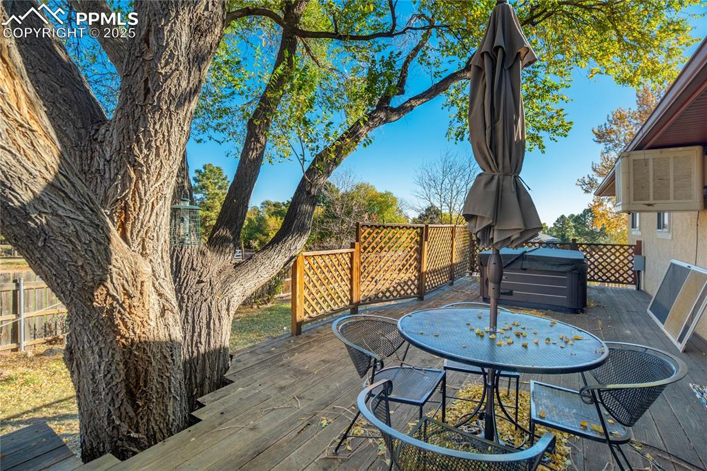 Image 45 of 48: Wooden terrace with outdoor dining area