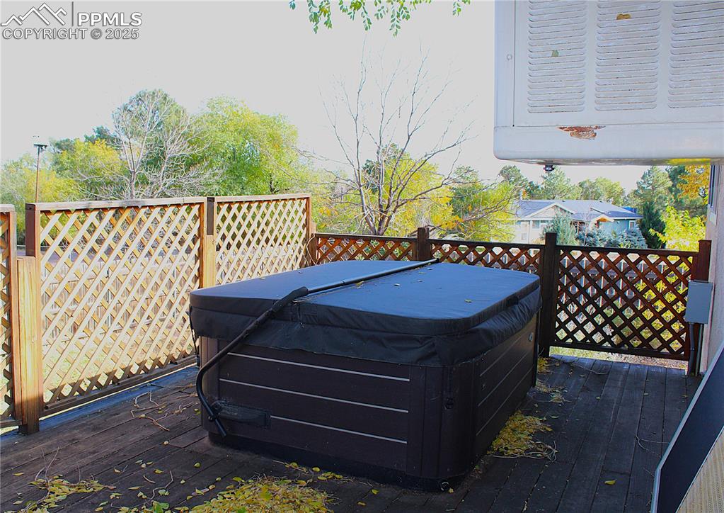 Image 5 of 48: Wooden deck featuring a 3-yr old hot tub