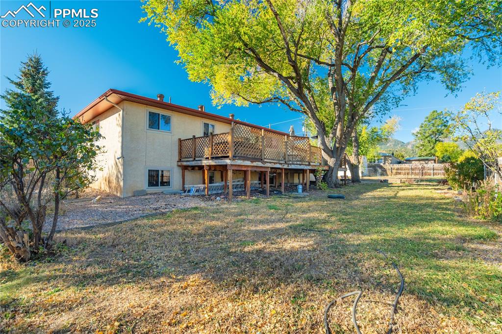 Image 7 of 48: Rear view of property with a deck and stucco siding