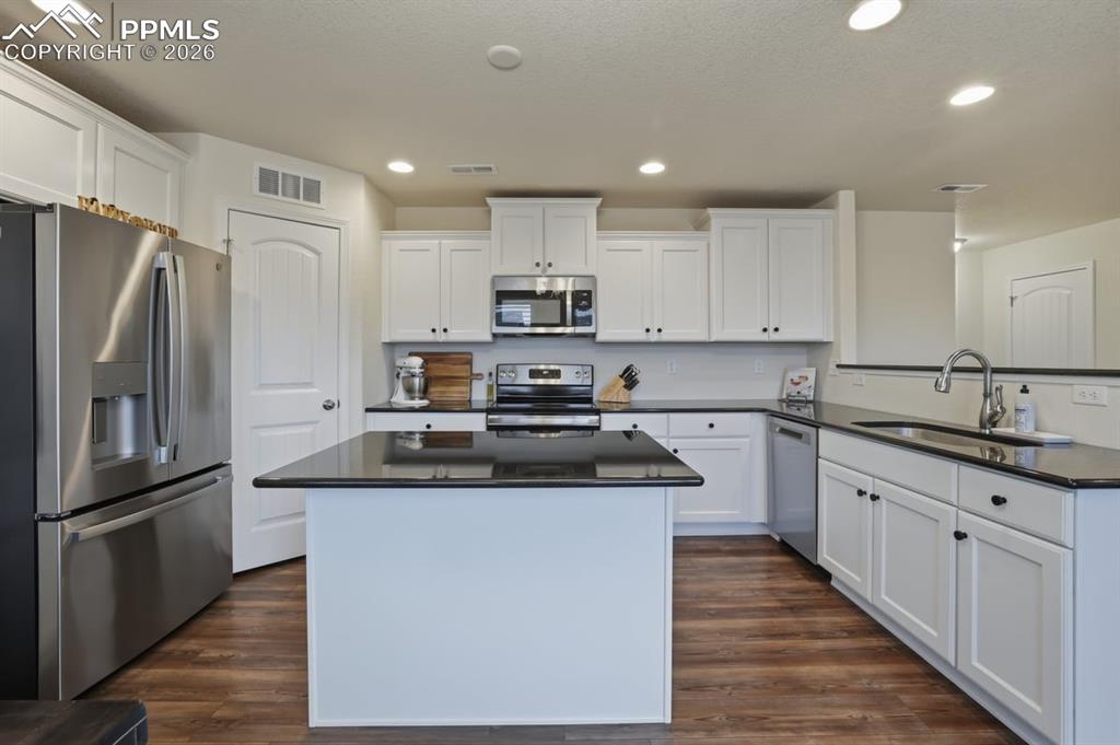 Image 10 of 38: bright white, staggered cabinets