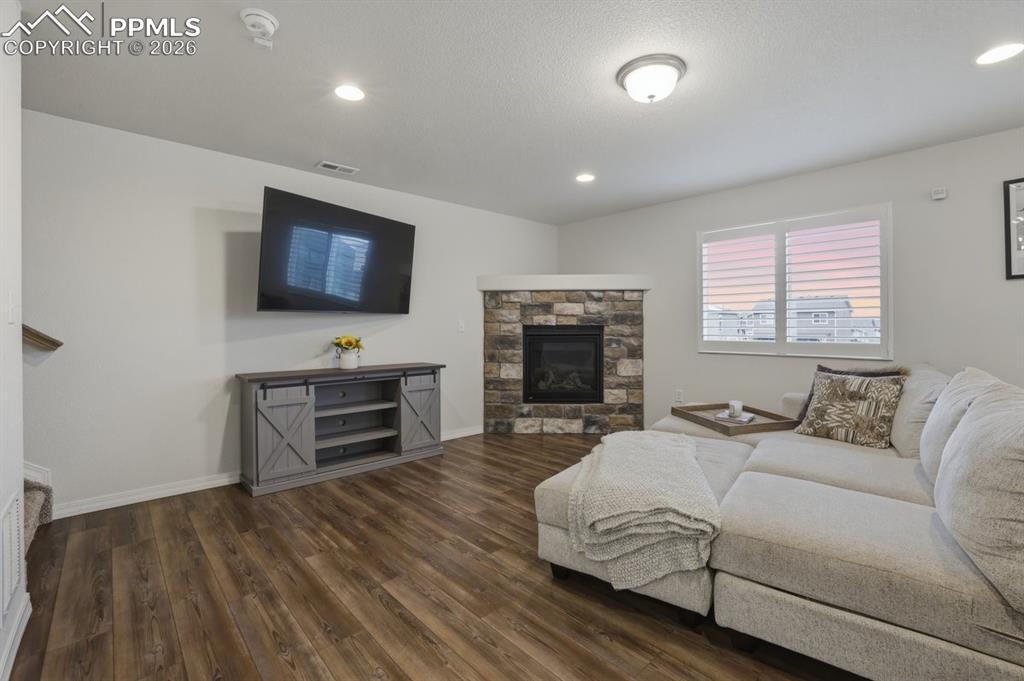 Image 6 of 38: LVT flooring, gas stone fireplace, plantation shutters