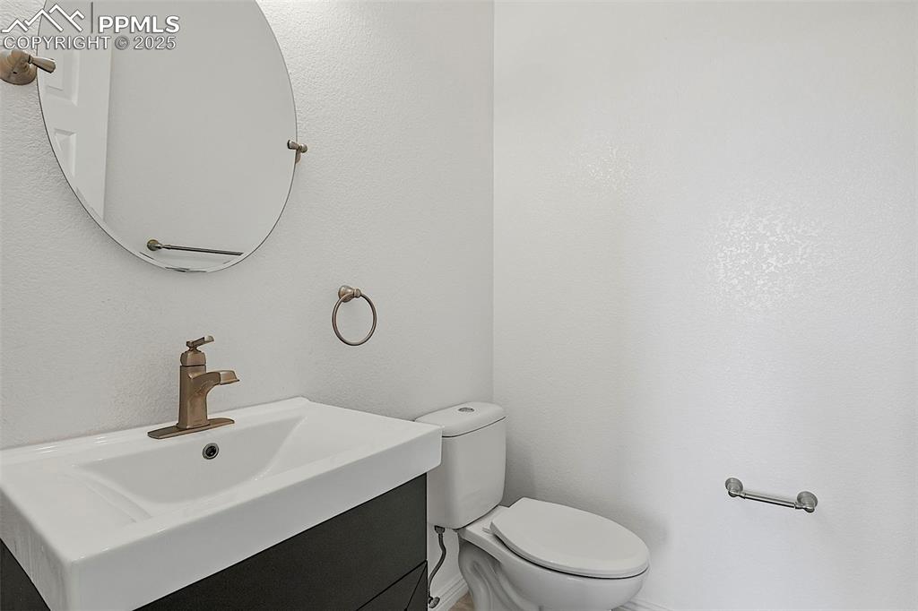 Image 16 of 48: Bathroom with toilet and vanity