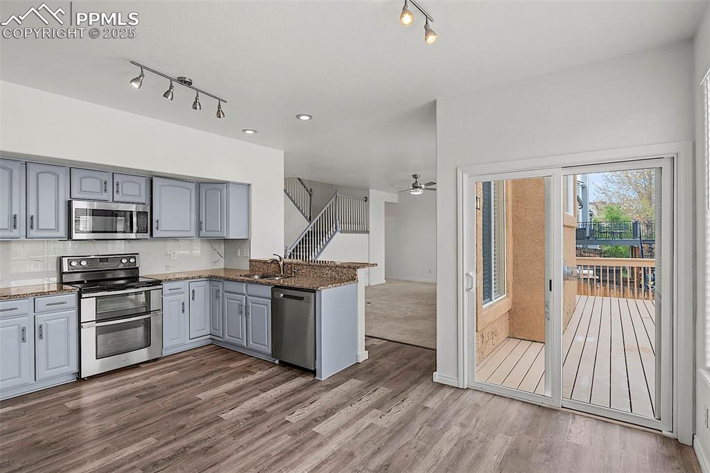 Image 22 of 48: Kitchen featuring appliances with stainless steel finishes, rail lighting, 