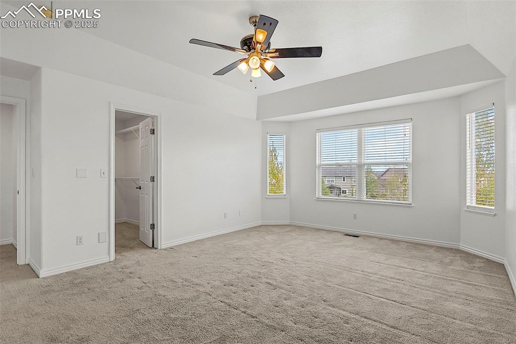 Image 26 of 48: Unfurnished bedroom featuring carpet floors, baseboards, a spacious closet,