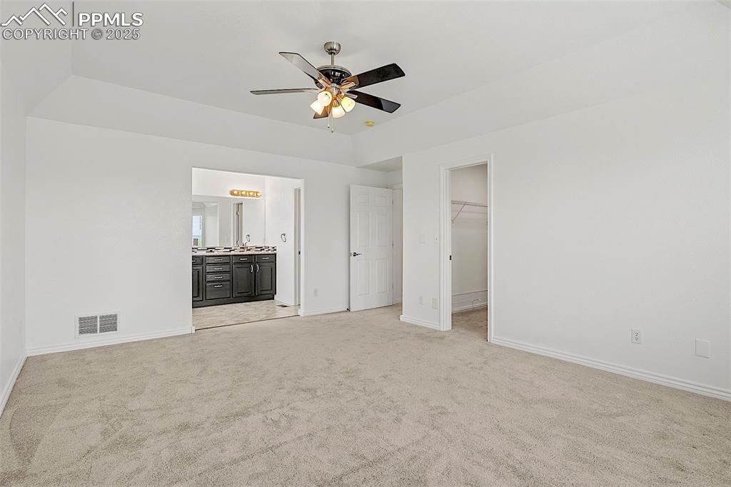 Image 27 of 48: Unfurnished bedroom featuring light colored carpet, a spacious closet, and 
