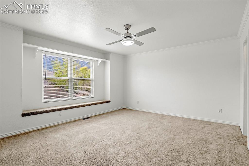 Image 30 of 48: Unfurnished room featuring carpet floors, a ceiling fan, baseboards, and or