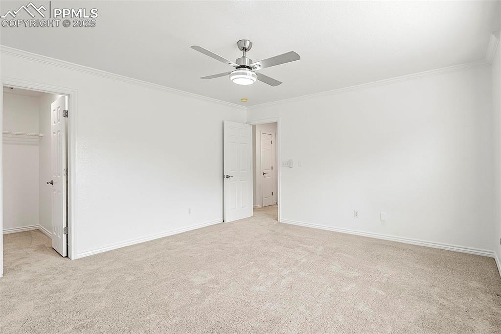 Image 31 of 48: Unfurnished bedroom with light colored carpet, a spacious closet, ornamenta