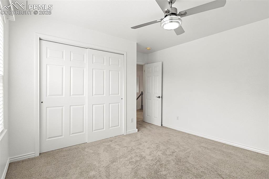 Image 34 of 48: Unfurnished bedroom featuring carpet flooring, a closet, baseboards, and ce