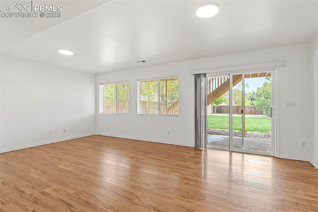 Image 36 of 48: Spare room with healthy amount of natural light, baseboards, and light wood