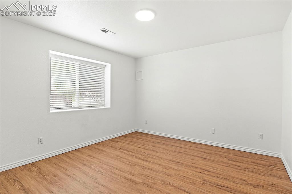 Image 41 of 48: Unfurnished room featuring light wood-type flooring and baseboards