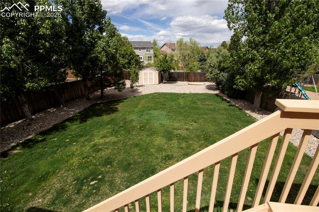 Image 45 of 48: View of yard with a storage unit, an outdoor structure, and a playground
