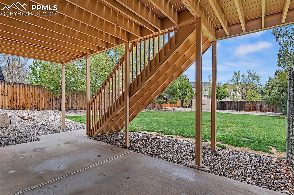 Image 48 of 48: View of patio with a storage shed, an outbuilding, and stairs