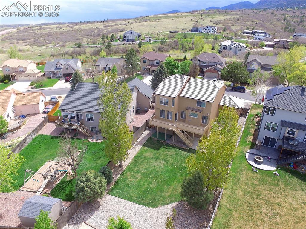 Image 5 of 48: Aerial view of residential area with a mountainous background