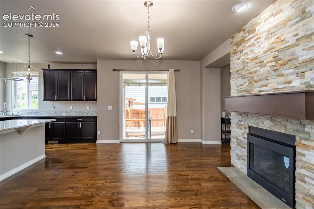 Image 11 of 45: Dining Area with double-sided fireplace and walk out to backyard