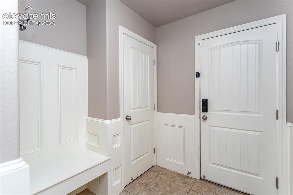 Image 18 of 45: Mud room with closet and bench