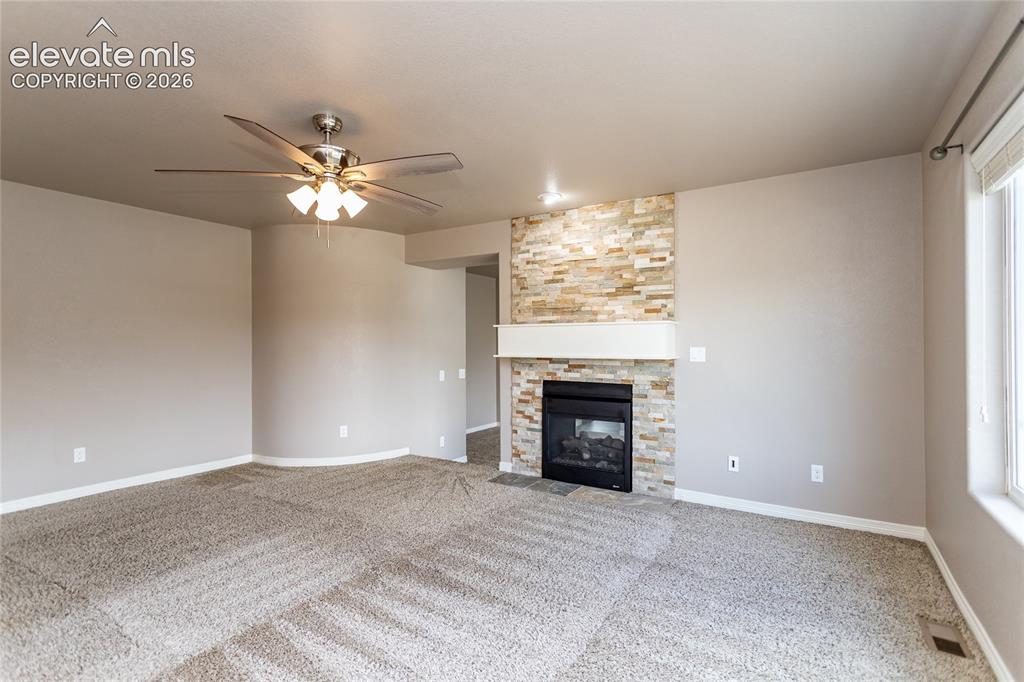 Image 26 of 45: Primary Bedroom with double-sided fireplace
