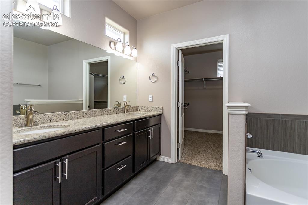 Image 27 of 45: Five piece primary bathroom with walk-in closet