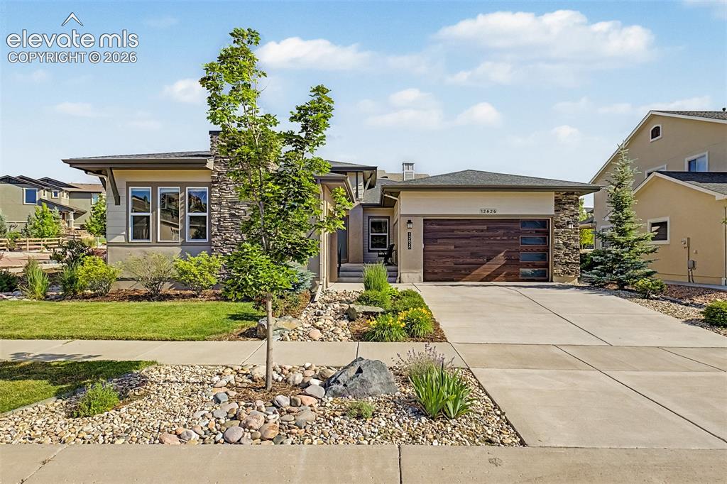Image 1 of 46: Striking custom garage doors enhance the home