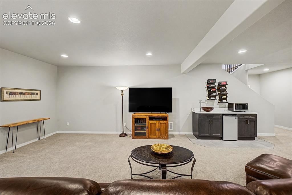 Image 33 of 46: Expansive basement family room offers versatile living space with easy acce
