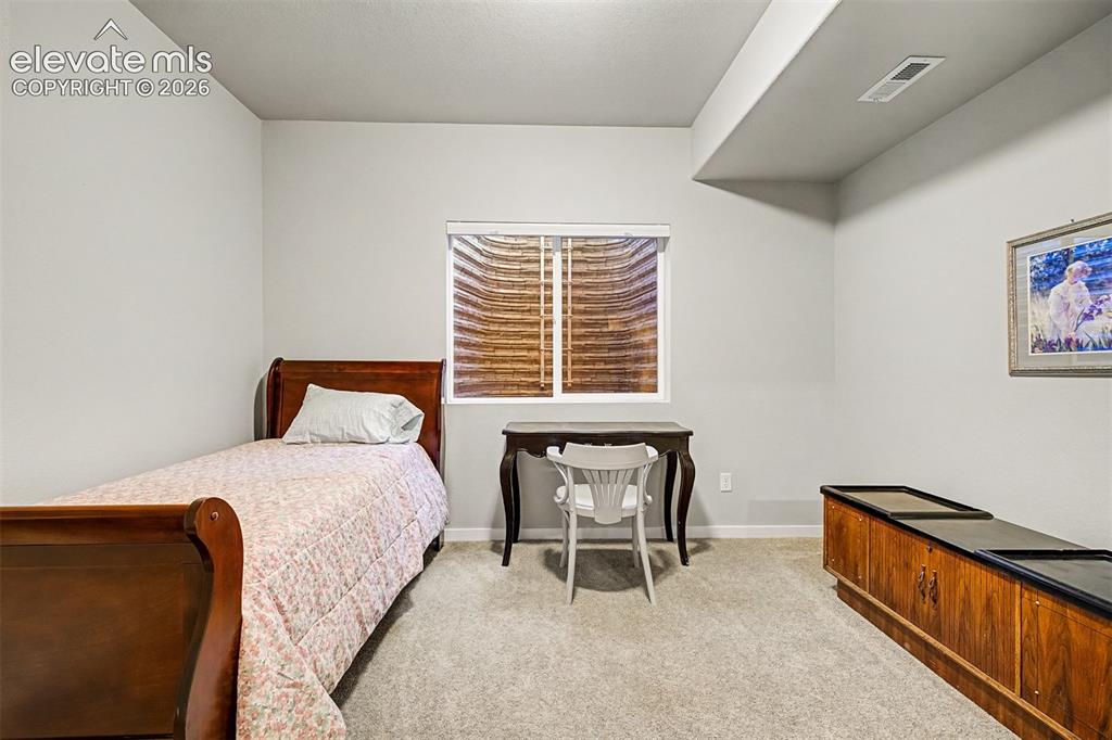 Image 35 of 46: One of two spacious basement bedrooms, conveniently situated near the lower