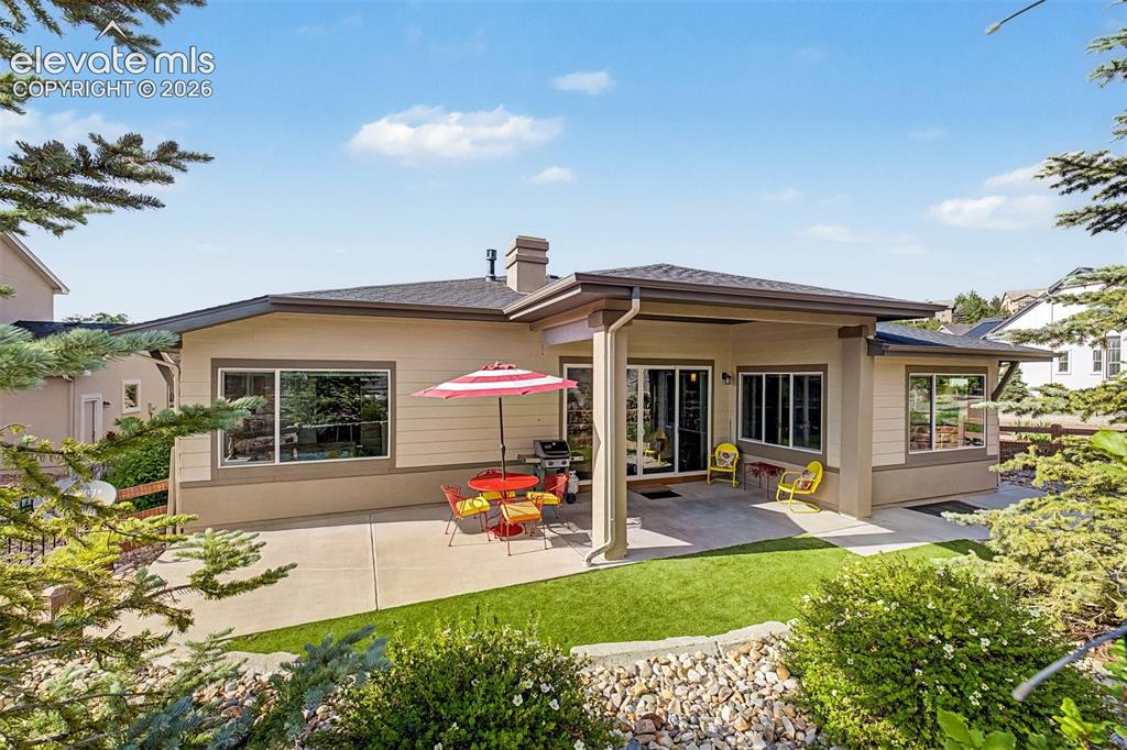Image 4 of 46: Complementing the front patio, the covered backyard patio offers a private 
