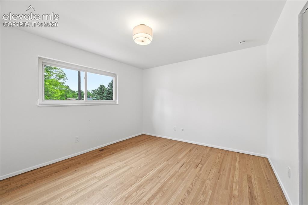 Image 11 of 30: Light-filled room featuring wood-finish flooring, a white ceiling with a fl
