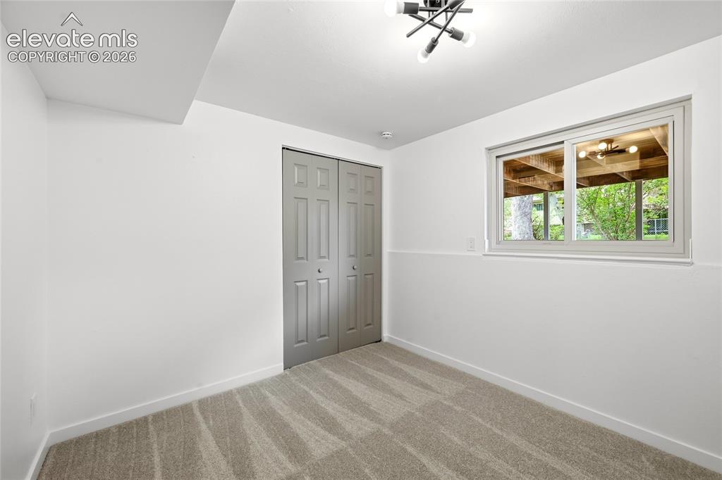 Image 19 of 30: Room featuring light-toned carpeting, white walls, and a contemporary ceili