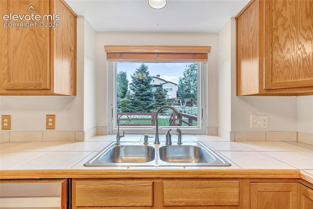 Image 13 of 47: The view from the kitchen out to your new backyard. The kitchen sink includ