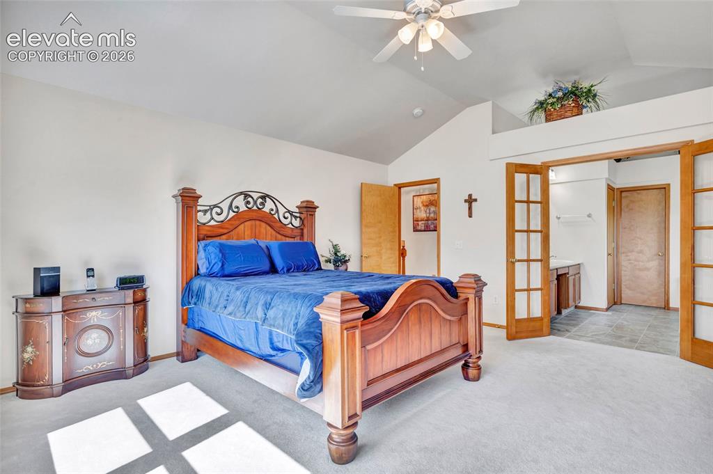 Image 16 of 47: Primary Bedroom with doors connecting it to the 5 piece bathroom. 