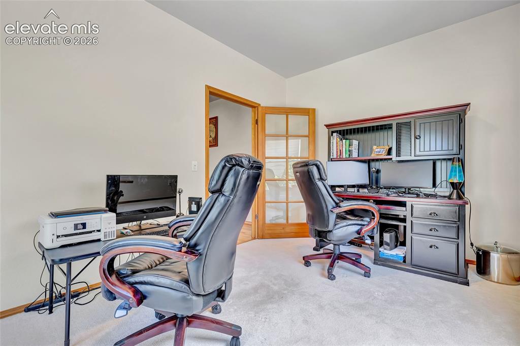 Image 30 of 47: Another view of the office on the main level of the house. 