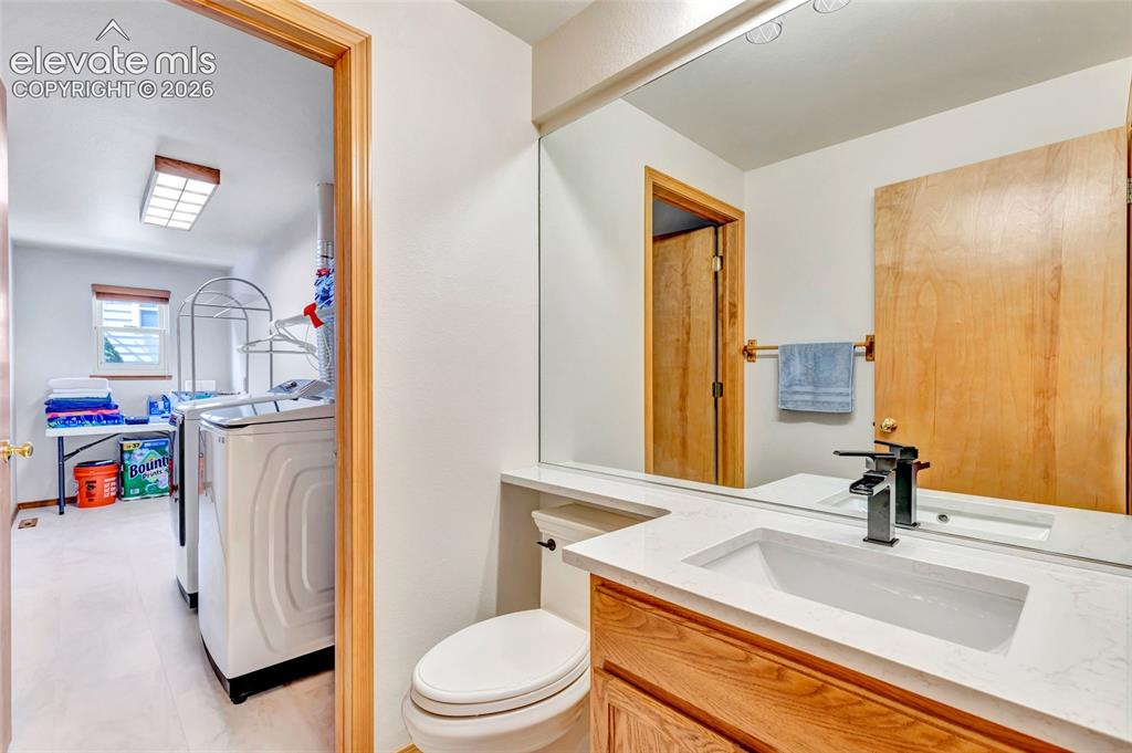 Image 31 of 47: Bathroom that leads to the laundry room on the main level of the house. 