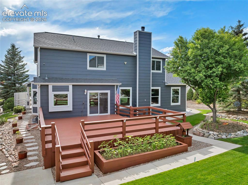 Image 39 of 47: The deck is ready for you and the grass is lush and beautiful. The home own