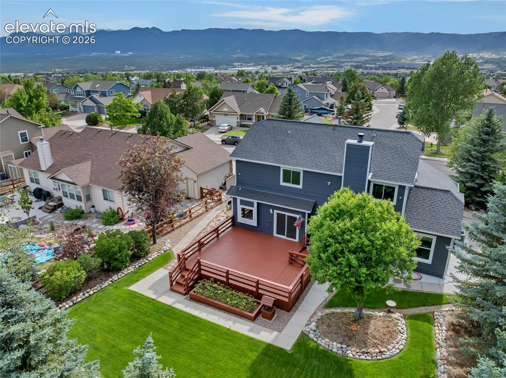 Image 41 of 47: Look at that deck and the yard! There are birdbaths and some yard art you c