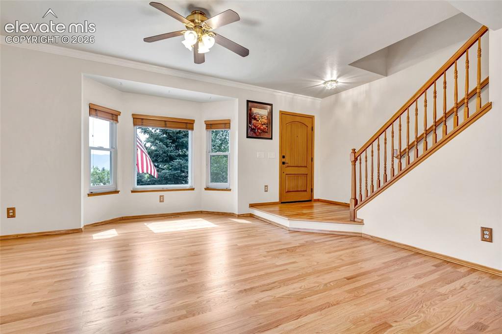Image 5 of 47: When you enter the house you are greated by the beautiful wood flooring. Th