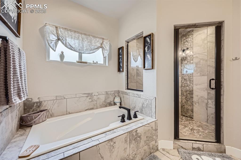 Image 14 of 27: Full bathroom featuring a shower stall and a garden tub