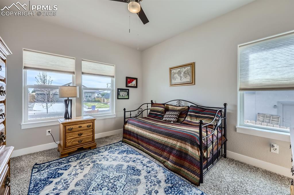 Image 15 of 27: Bedroom with baseboards, carpet, and a ceiling fan