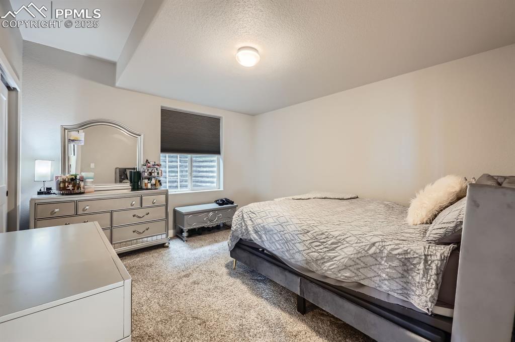 Image 22 of 27: Carpeted bedroom featuring a textured ceiling
