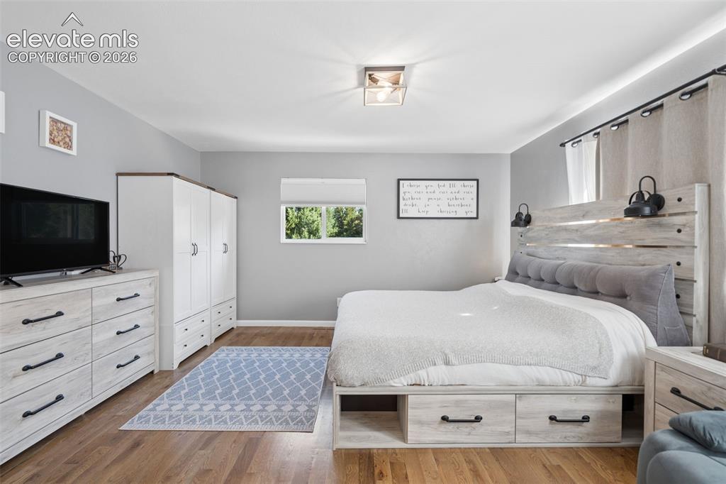 Image 15 of 49: Wood-finish flooring, neutral wall tones, window with exterior exposure, an